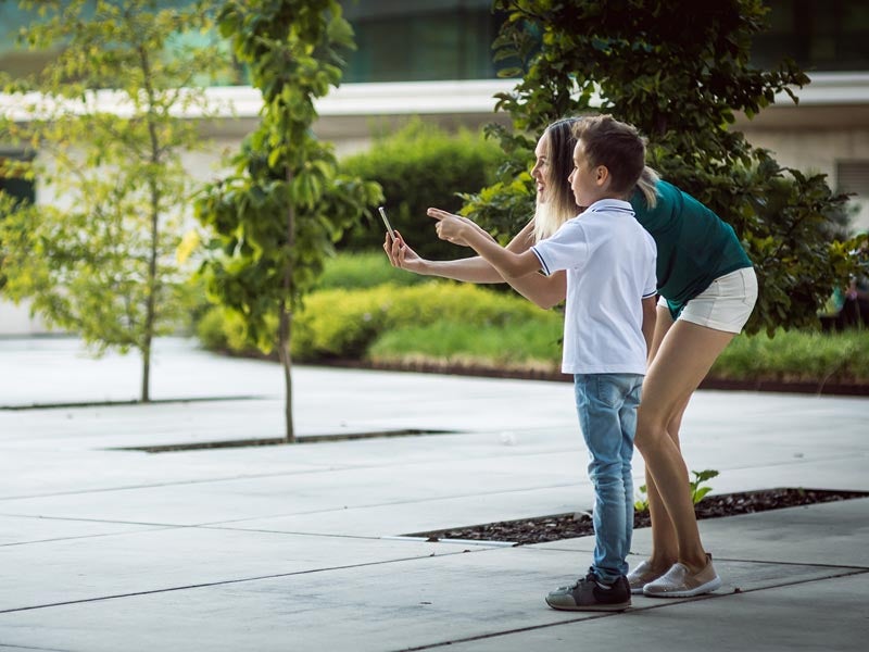 mother and son using up their data bank during the school holidays with photos